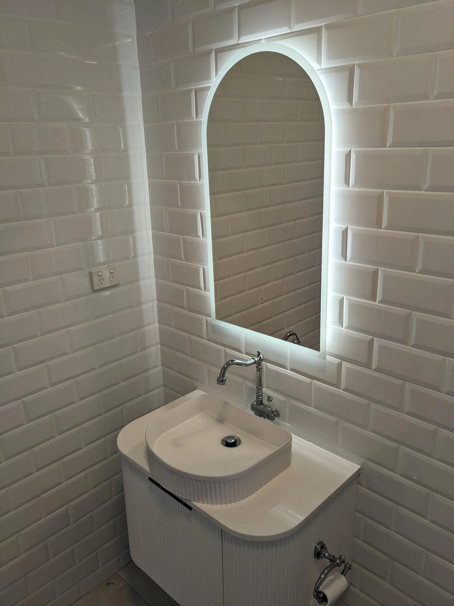 Professional tiling — white subway tiles with arch LED mirror by Sunshower